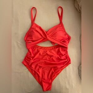 One piece bright red-orange one piece with mid drift cut out.  Size large.